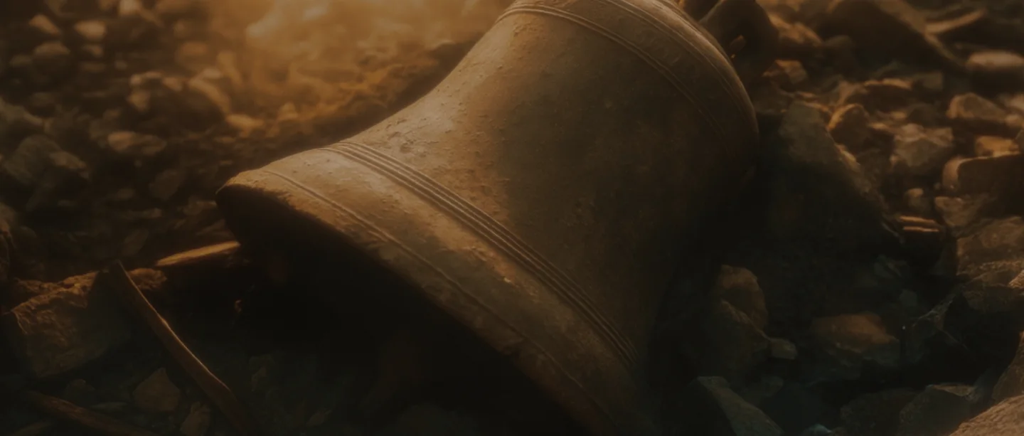 A cathedral bell lies among the rubble